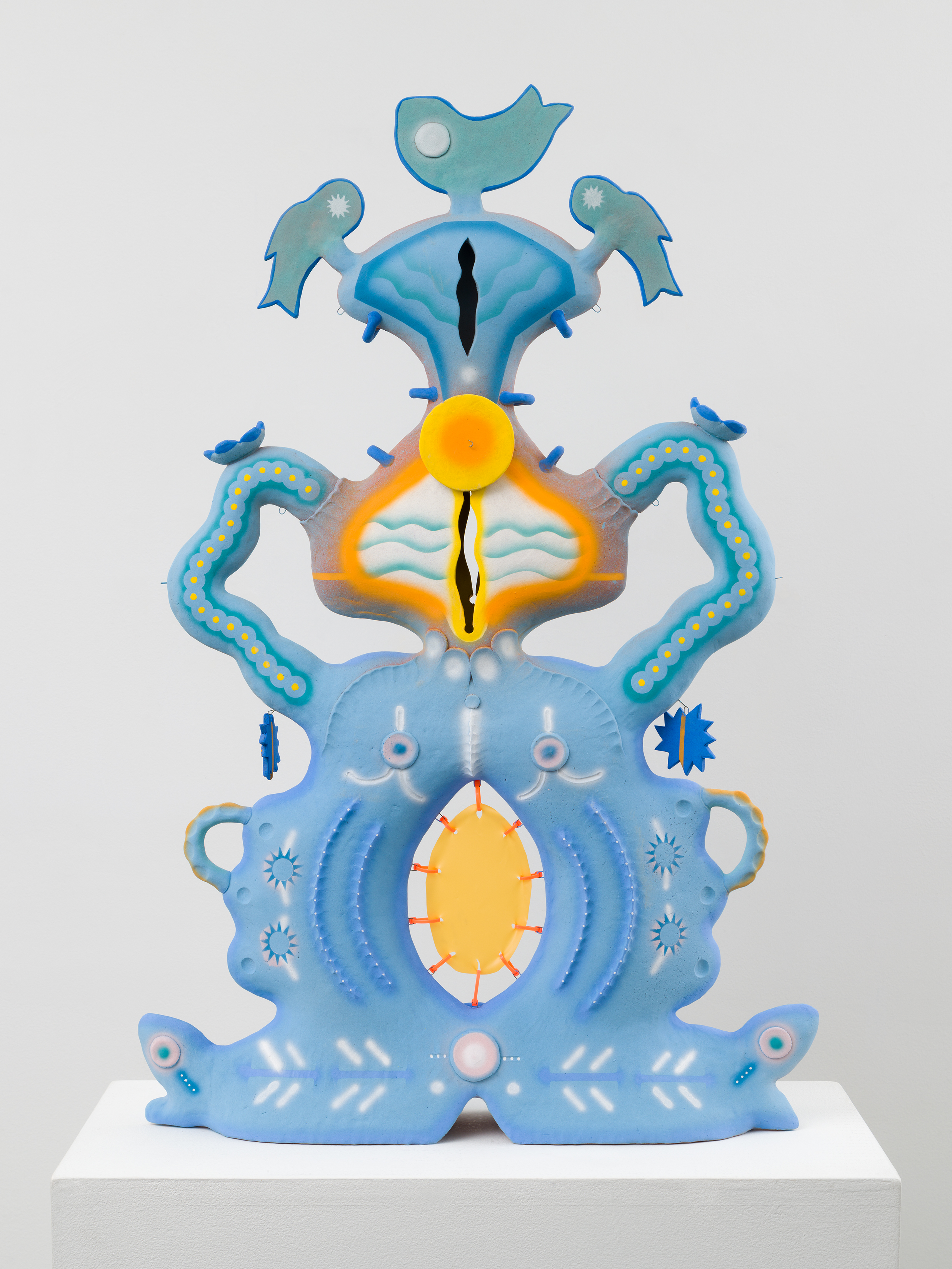 a ceramic sculpture by Chenlou Hou, in pale blue with yellow accents. the title is "In memory of the auntie with a gold tooth who butchered a carp right in front of you" and it is symmetric composition of abstracted carp facing each other with smaller ornaments dangling and attached with high temperature wire.