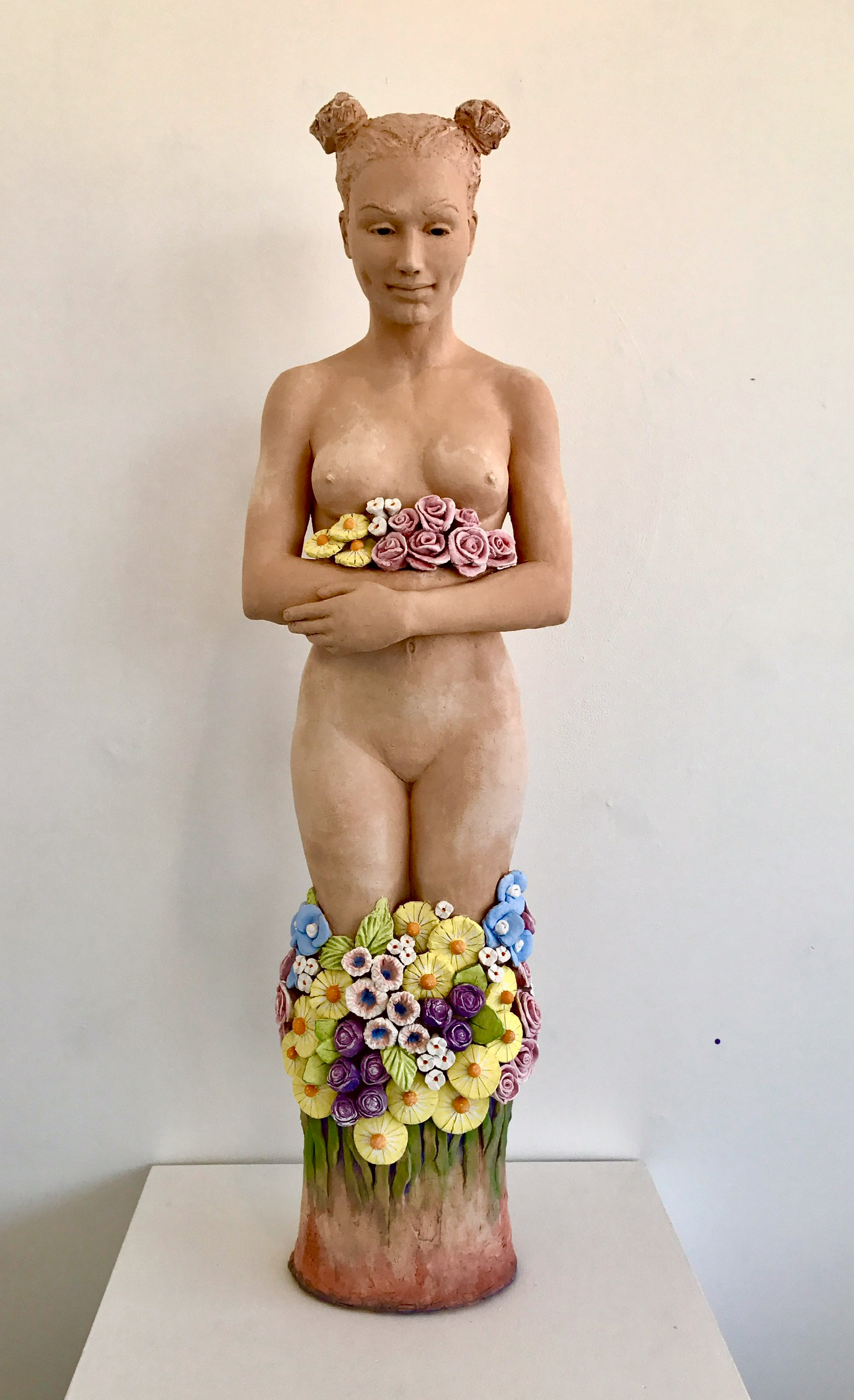sculpture of a woman with flowers