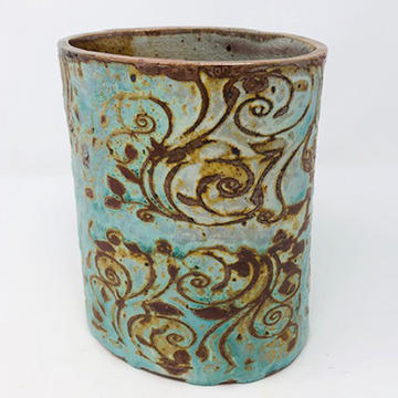 ceramic cup with embossed floral design