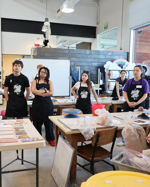 Students take in an explanation of the clay material by Kathy King