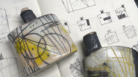 ceramic bottles on a sketchbook