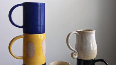 mugs stacked by Adriana Sousa, blue, yellow, black and white