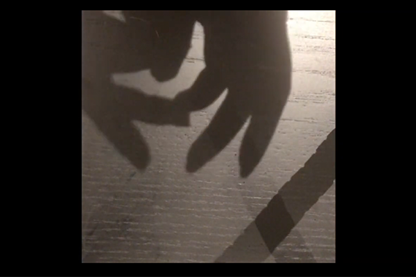 Screenshot from the video. Artistic image of hands.