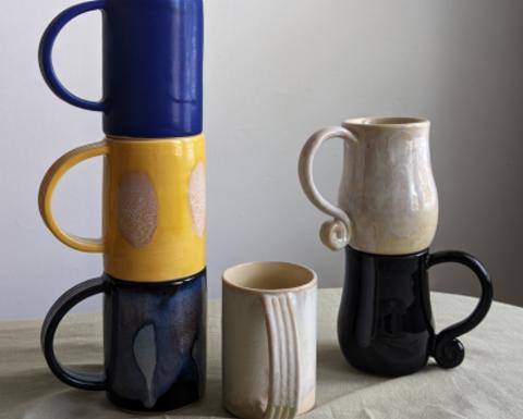 mugs stacked by Adriana Sousa, blue, yellow, black and white